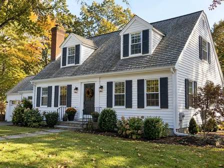 White clapboard home with charcoal shutters — Connecticut residential design inspiration