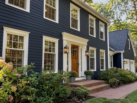 Deep navy home exterior with warm wood accents — Connecticut residential design inspiration