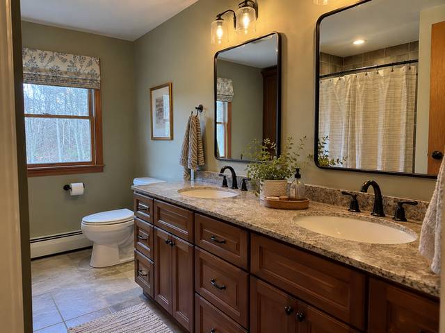 Double vanity with coordinated mirrors and lighting — Connecticut residential design inspiration