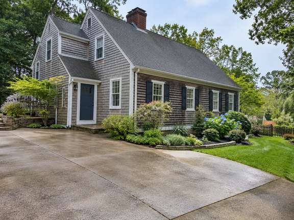 Clean driveway with a neat garden border — Connecticut residential design inspiration